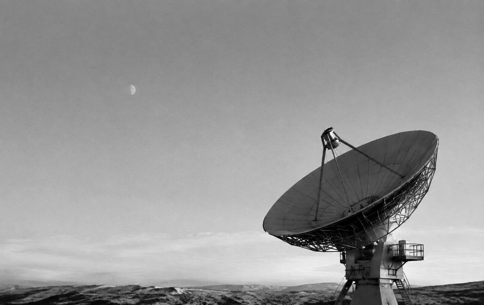 A ground station antenna under a wide sky